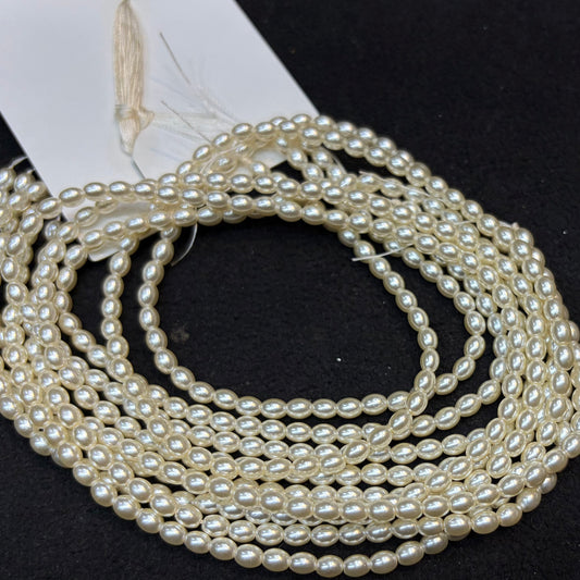 Metallic cream colour high quality oval shape pearl beads 1 string.