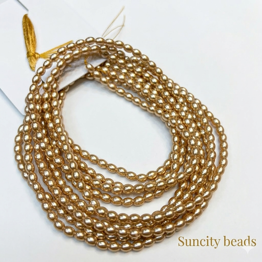 Metallic light golden colour high quality oval shape pearl beads 1 string.