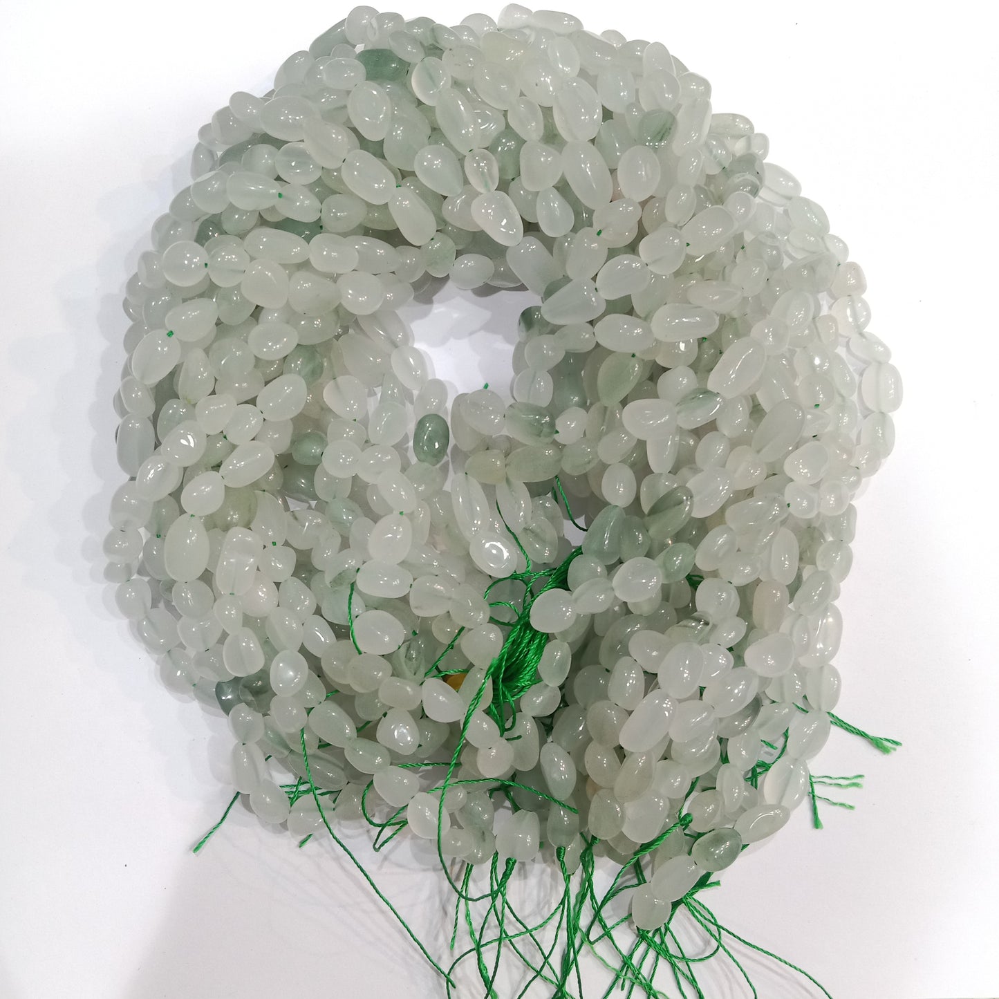 pale green or greenish-white.  tumbel stones beads 1 string