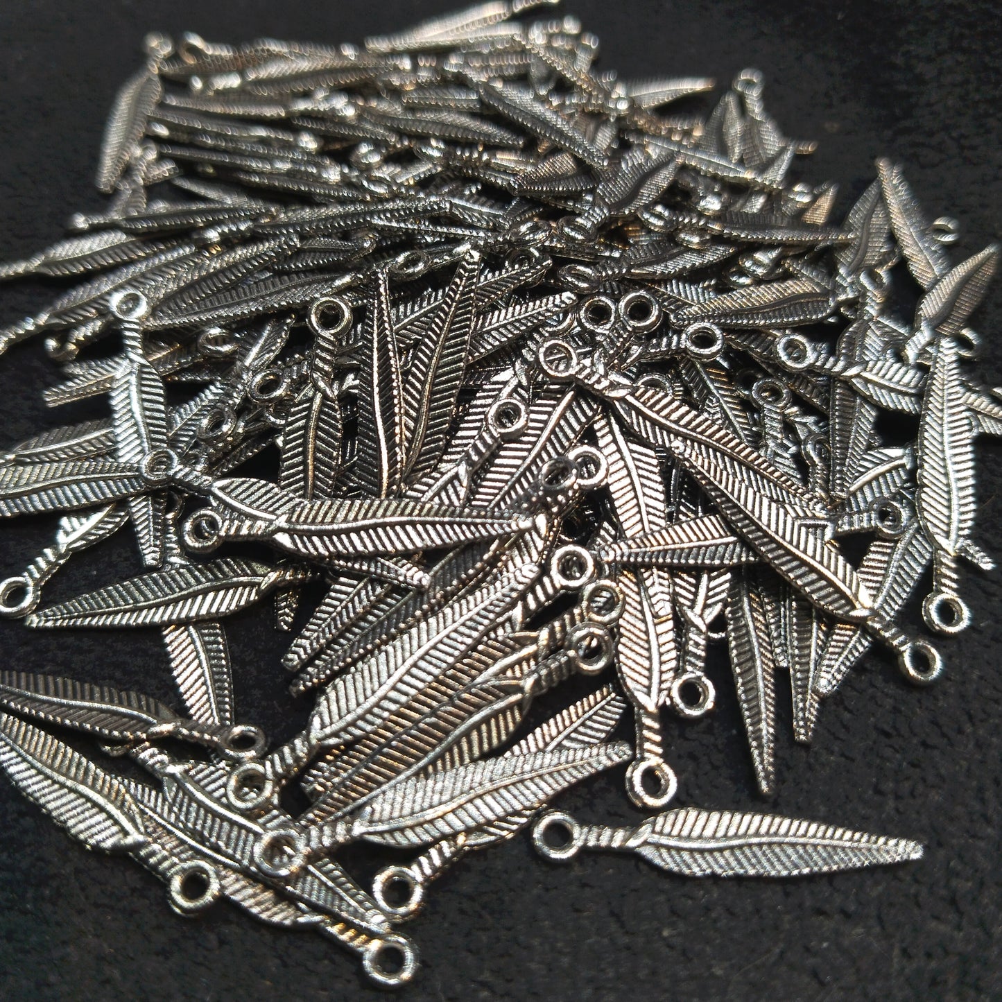Oxidized silver feather ribbed charms 18mm 1 pkt 60 pcs.